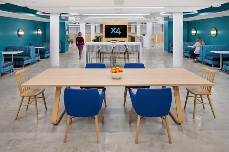Image shows booths and tables at the X4 headquarters in Boston.